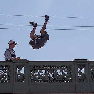 Street entertainer, St Petersburg. Pair of lads who track river tourists and perform at the bridges, here one turns somersalt.